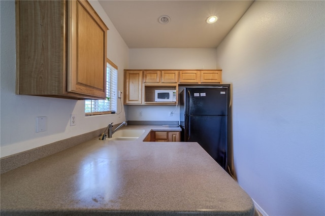 2041 E Sundance Dr, Fort Mohave, AZ 86426 - kitchen featuring white microwave, freestanding refrigerator, a peninsula, and recessed lighting