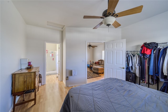2041 E Sundance Dr, Fort Mohave, AZ 86426 - bedroom with attic access, light wood finished floors, a ceiling fan, and ensuite bath