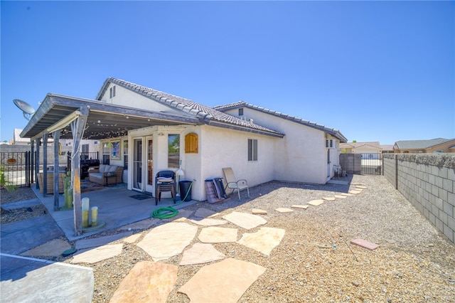 2041 E Sundance Dr, Fort Mohave, AZ 86426 - rear view of house with stucco siding, a patio, a fenced backyard, and a tiled roof