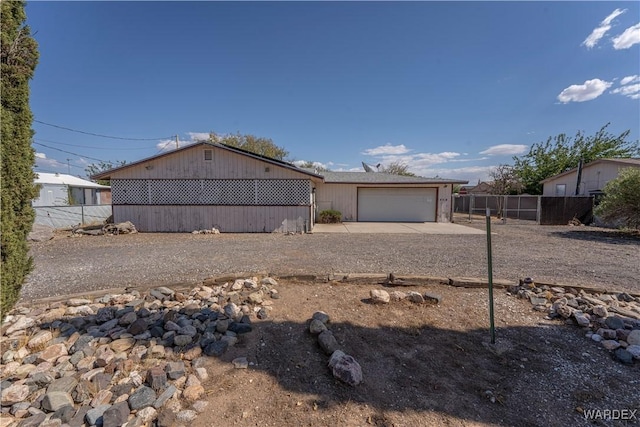 view of front of property featuring a garage and fence