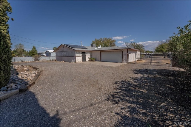 view of front facade featuring a garage, fence, and driveway