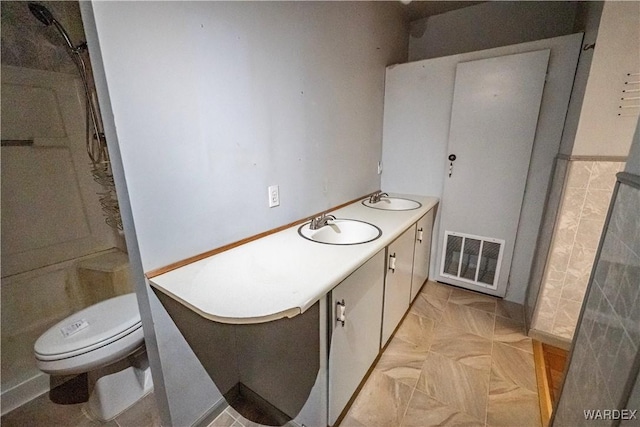 full bath with toilet, double vanity, a sink, and visible vents