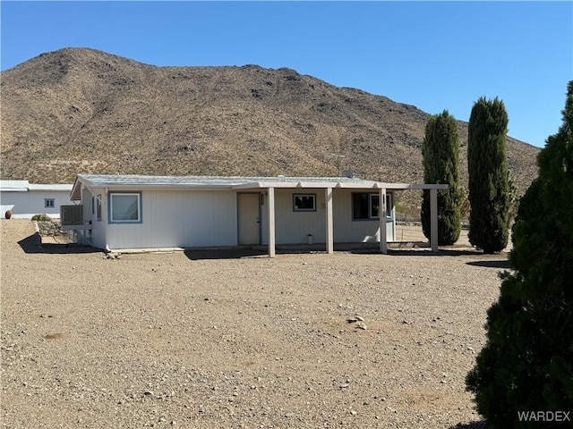 rear view of property featuring a mountain view