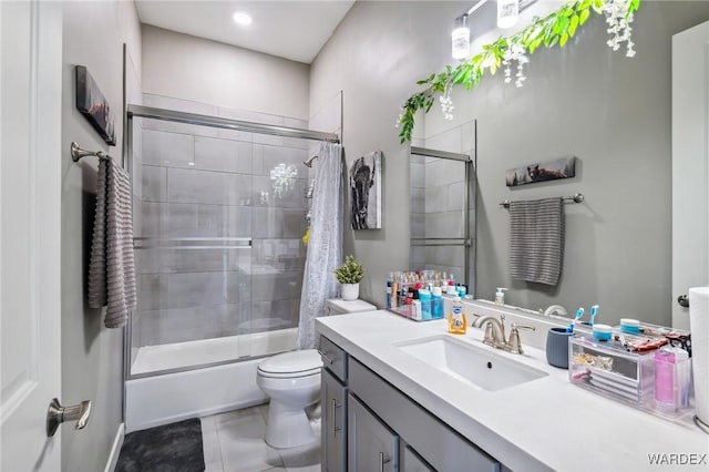 full bathroom with shower / bath combination with glass door, vanity, toilet, and tile patterned floors