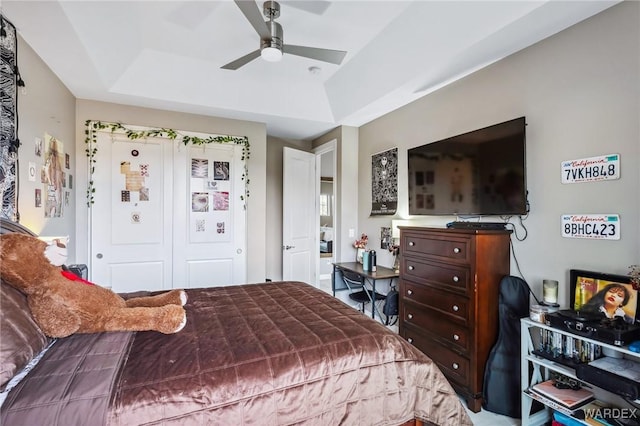 bedroom featuring a ceiling fan and a tray ceiling