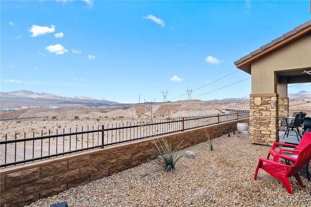 view of yard with fence and a mountain view