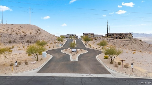 view of street featuring a mountain view and curbs