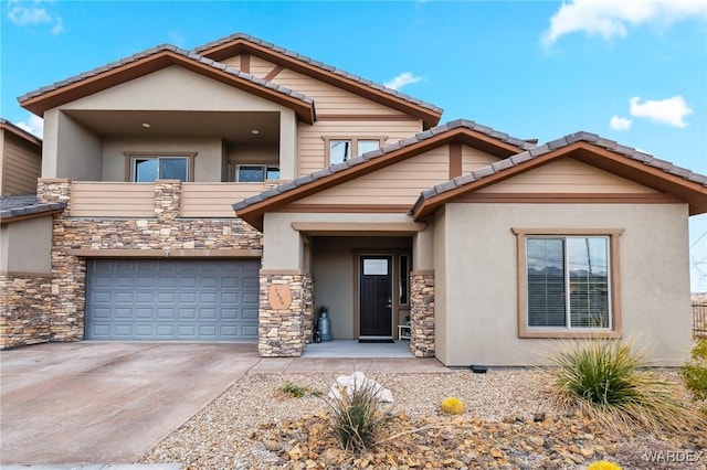 view of front facade featuring an attached garage, concrete driveway, stone siding, and stucco siding