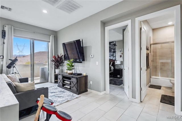 living area featuring light tile patterned floors, baseboards, visible vents, and recessed lighting