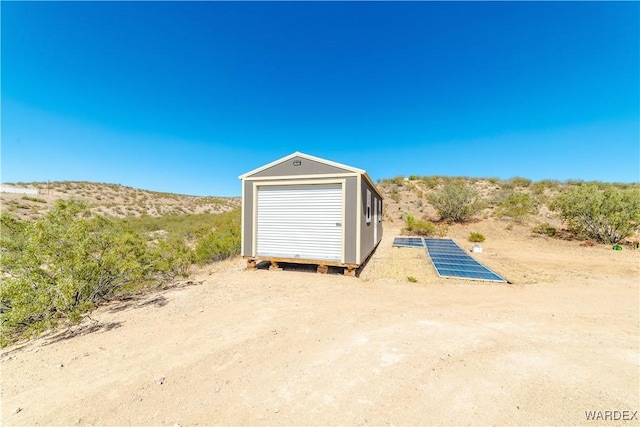 view of outbuilding with solar panels