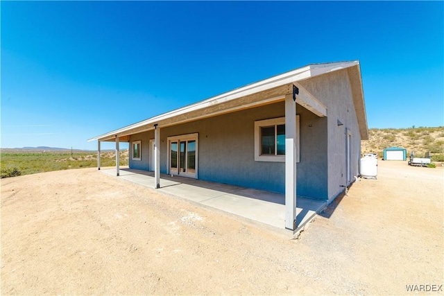 exterior space with a patio area and stucco siding