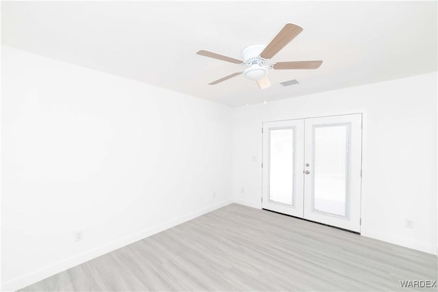 empty room featuring a ceiling fan, visible vents, baseboards, french doors, and light wood finished floors