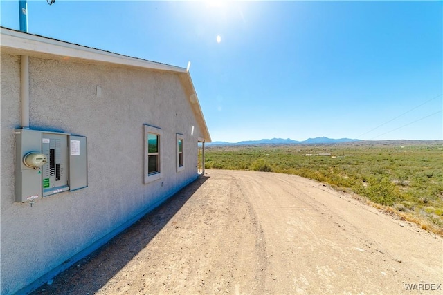 view of property exterior featuring a mountain view and stucco siding