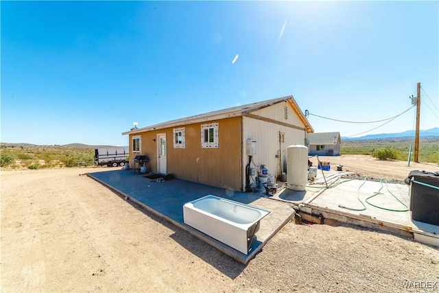 back of property featuring a mountain view