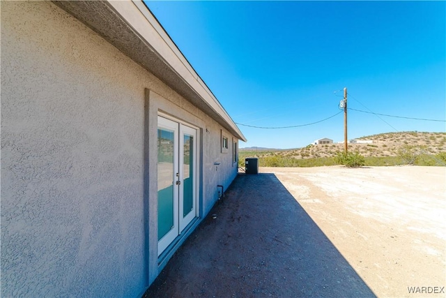 view of side of home with stucco siding