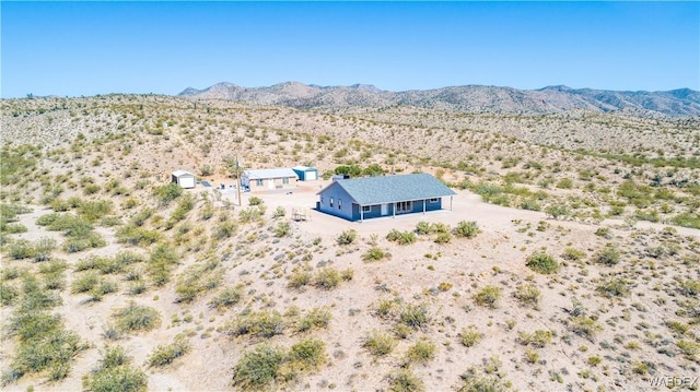 birds eye view of property with view of desert and a mountain view