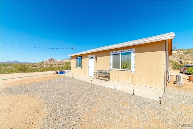 back of house featuring a patio and a mountain view