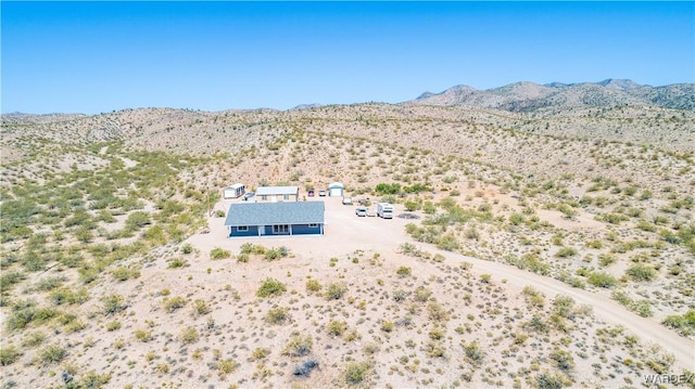 birds eye view of property with view of desert and a mountain view