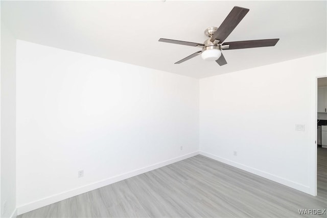 unfurnished room with baseboards, ceiling fan, and light wood-style floors