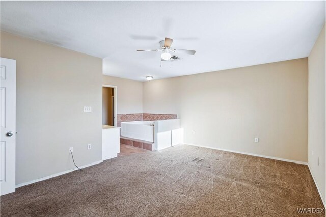 spare room with visible vents, carpet, a ceiling fan, and baseboards