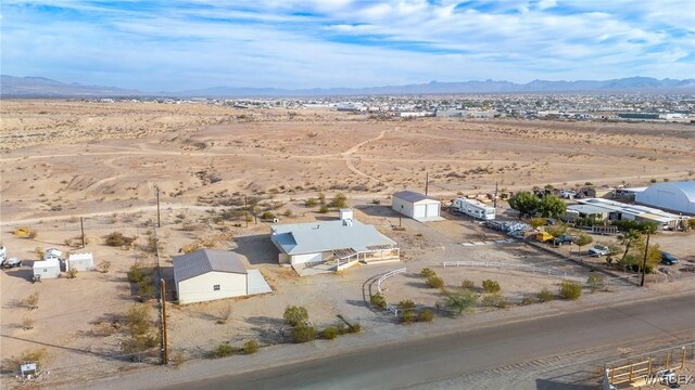 birds eye view of property featuring view of desert and a mountain view