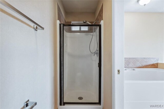 full bathroom featuring a stall shower