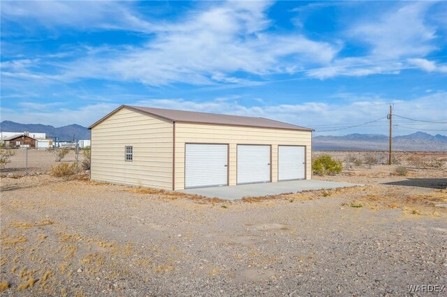 detached garage featuring a mountain view