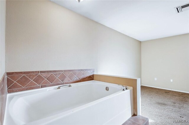 bathroom featuring visible vents and a garden tub