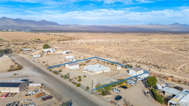 drone / aerial view featuring a mountain view and view of desert