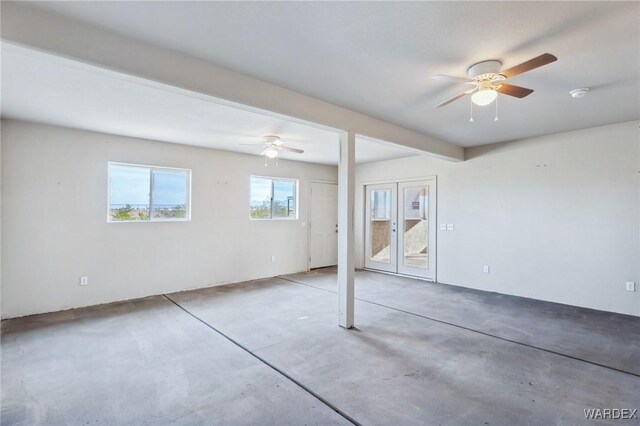 spare room with concrete floors and a ceiling fan