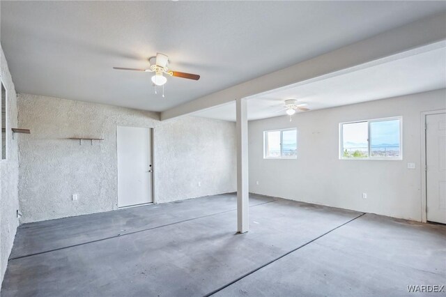 interior space with ceiling fan