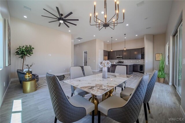 dining area featuring light wood-style floors, baseboards, visible vents, and recessed lighting