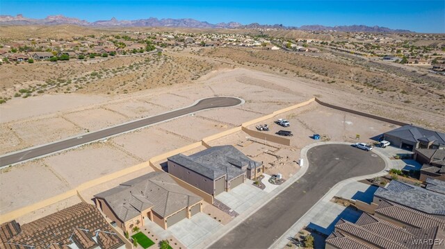 aerial view featuring a residential view, a desert view, and a mountain view