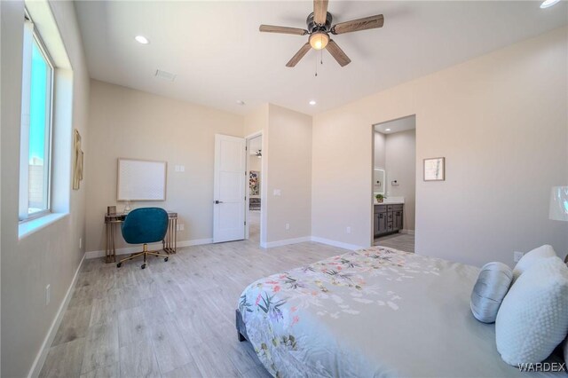 bedroom with visible vents, baseboards, ensuite bath, light wood-type flooring, and recessed lighting