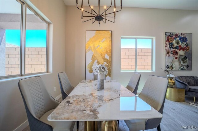 dining area with an inviting chandelier