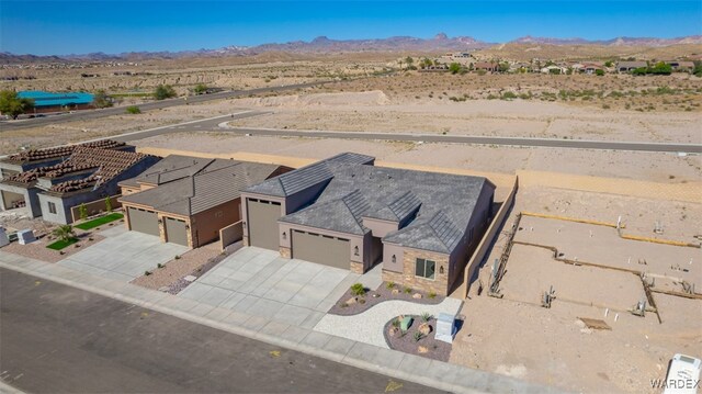 drone / aerial view with view of desert and a mountain view