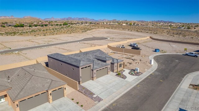 birds eye view of property featuring a mountain view and view of desert