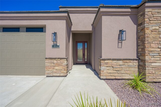 view of exterior entry featuring stone siding and stucco siding