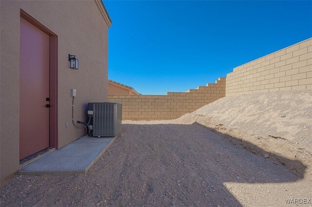 view of yard with a fenced backyard and central air condition unit