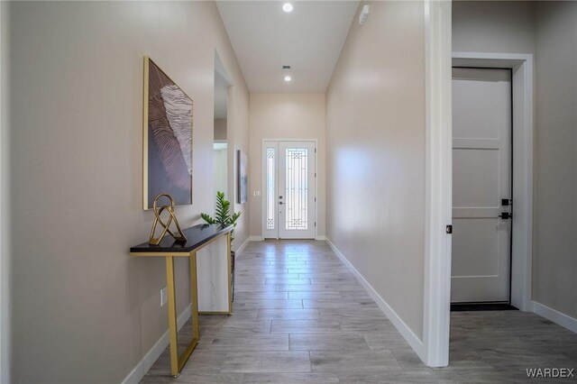 entryway featuring light wood-style floors, recessed lighting, and baseboards