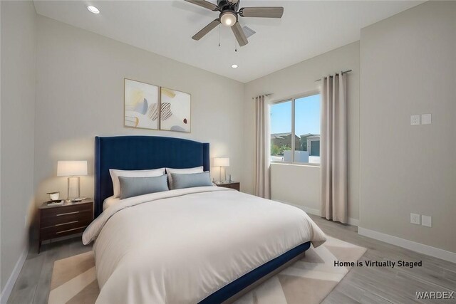 bedroom with recessed lighting, ceiling fan, light wood-style flooring, and baseboards