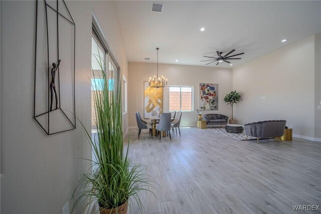 dining room with recessed lighting, light wood-style flooring, visible vents, and ceiling fan with notable chandelier