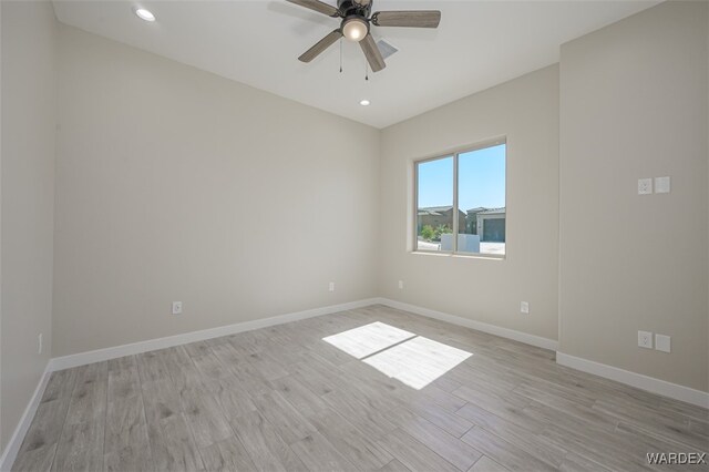 spare room featuring recessed lighting, light wood-type flooring, a ceiling fan, and baseboards