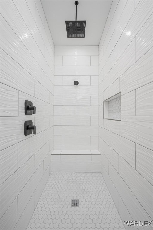 full bath with a tile shower