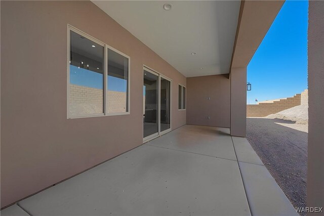 view of patio / terrace featuring fence