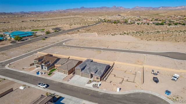 drone / aerial view with view of desert and a mountain view