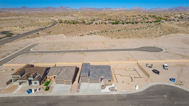 birds eye view of property featuring view of desert and a mountain view