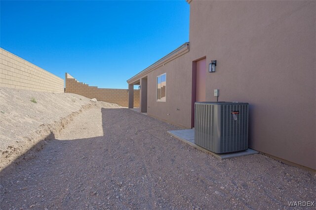 view of yard with central AC unit and a fenced backyard