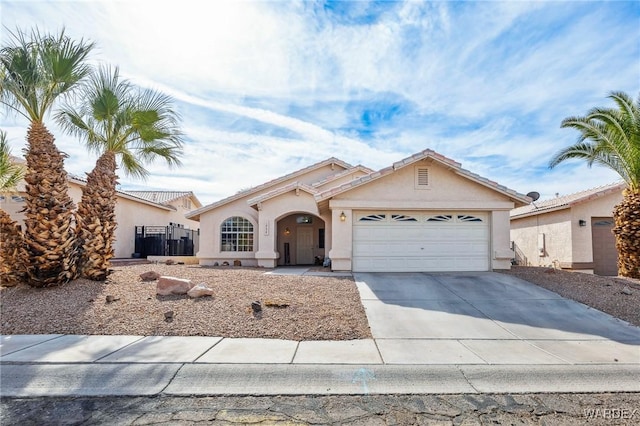 view of front of property with a garage, concrete driveway, and stucco siding