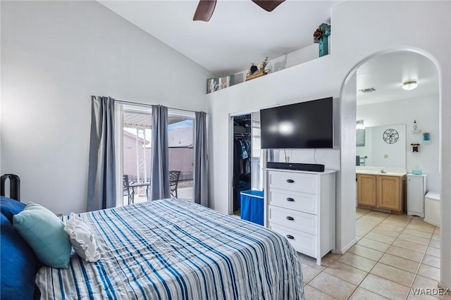 bedroom featuring light tile patterned flooring, a ceiling fan, vaulted ceiling, a closet, and ensuite bath